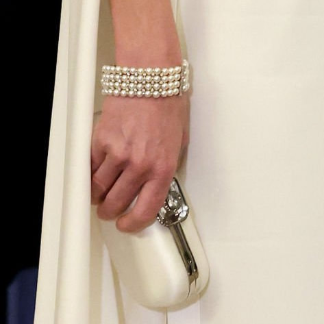 Princess Kate wears Princess Diana's four-stranded pearl bracelet and carried her white Alexander McQueen butterfly box clutch.