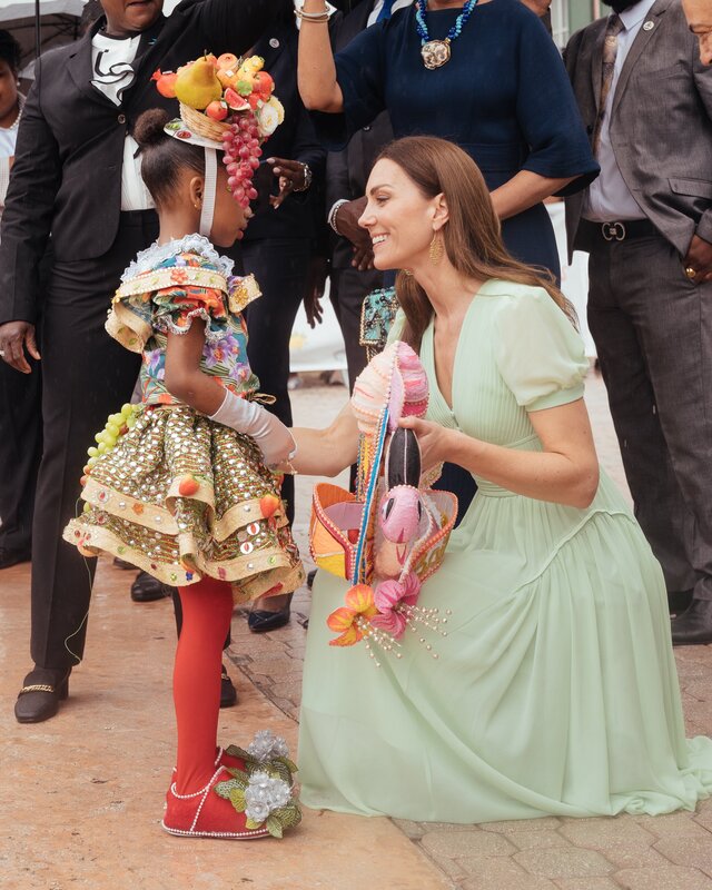 The Duchess of Cambridge chats to a young girl at the junkanoo street parade in Rawson Square, Bahamas 2022
