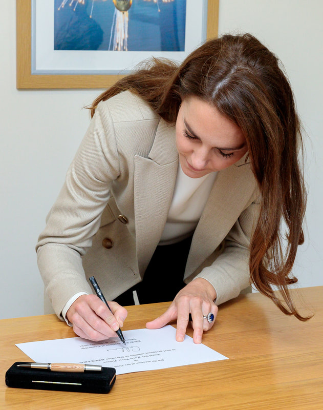The Duchess of Cambridge marked her visit to RAF Brize Norton by signing a commemorative document.